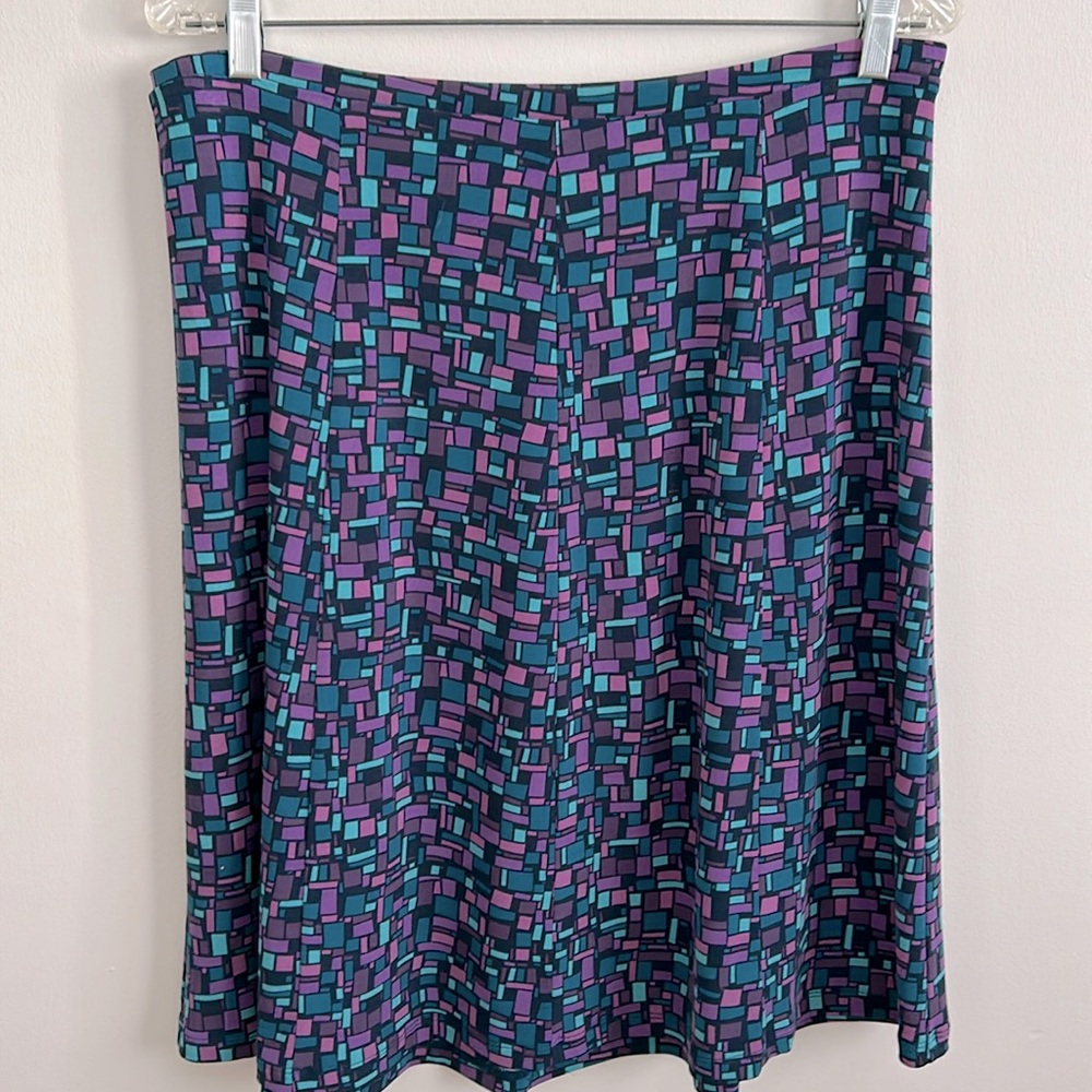 Flared skirt by YZZA in purple, turquoise & black. Polyester, elastic waist. Med